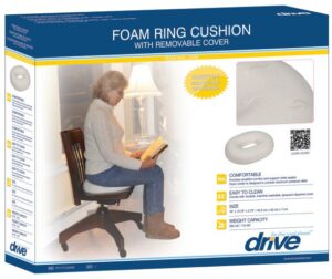 A woman sits on the Drive RTLPC23388 foam ring cushion, reading. The packaging emphasizes comfort, easy cleaning, and specific dimensions.