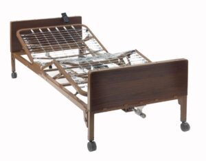 Adjustable hospital bed with wooden headboard and metal frame.