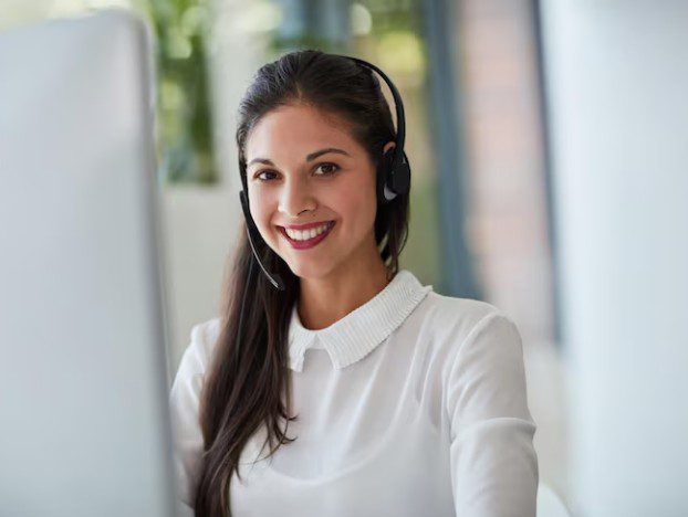 Smiling female customer service representative wearing a headset.