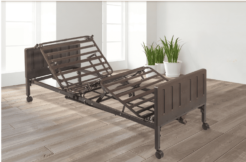 Adjustable hospital bed frame in a bright room with plants.