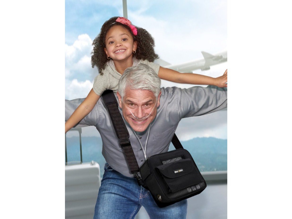 Happy grandfather giving granddaughter a piggyback ride outdoors.